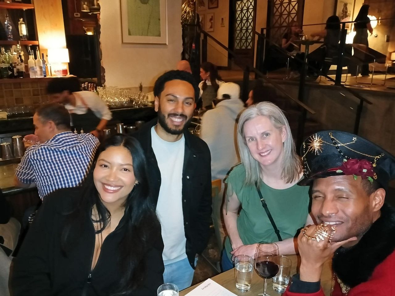 Four Full Spread Party guests smiling together after dinner