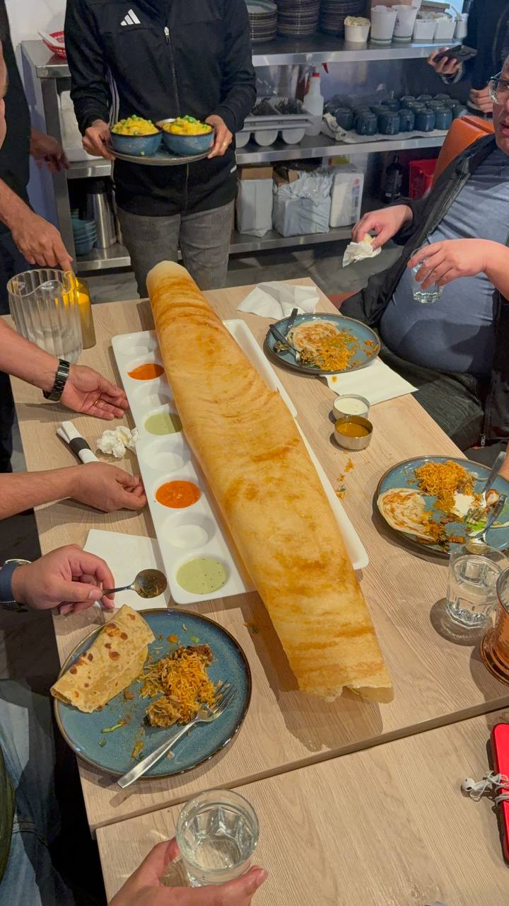 A giant dosa shared at the table