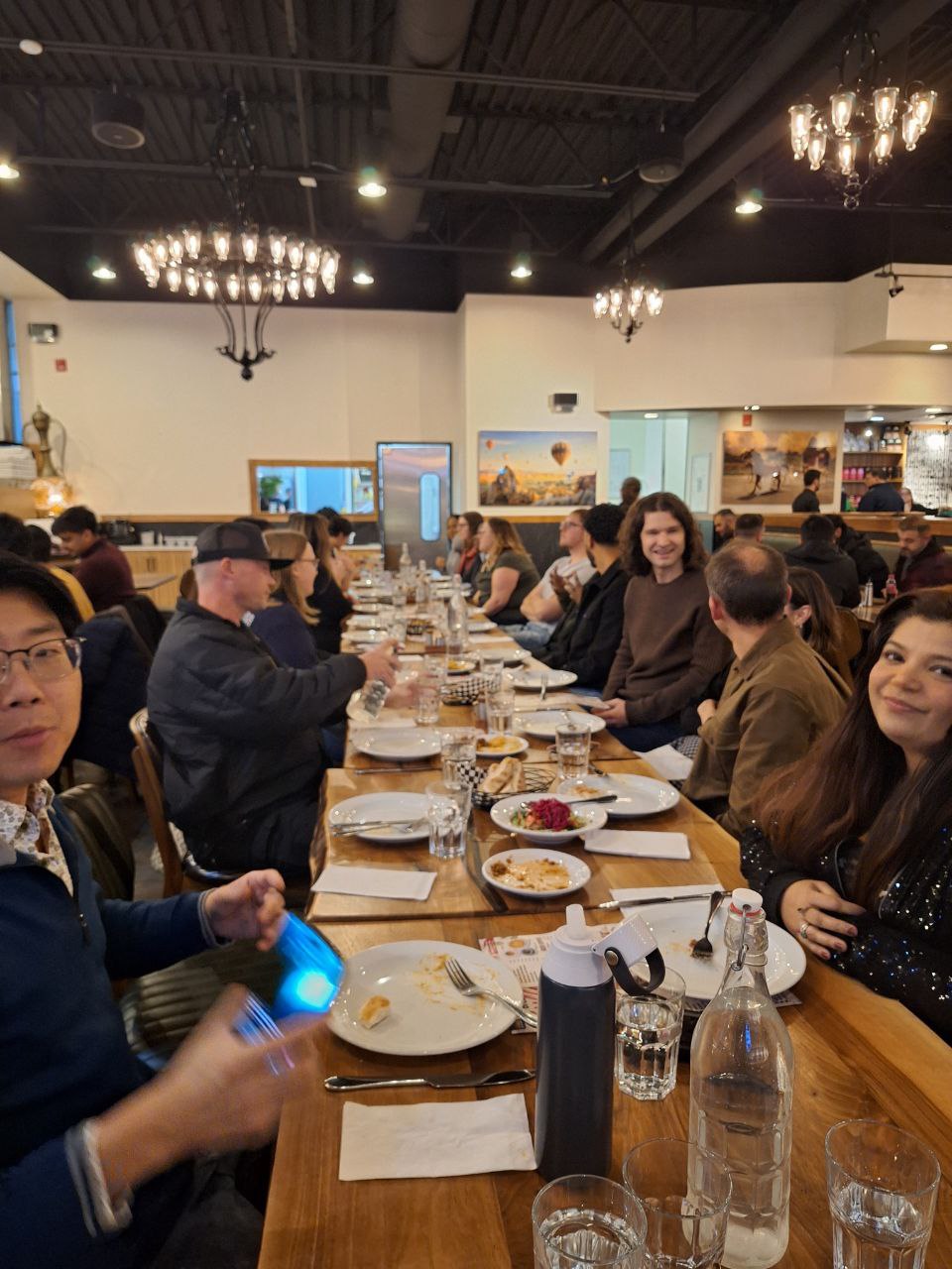 Guests gathered around a long shared table at a Full Spread Party dinner