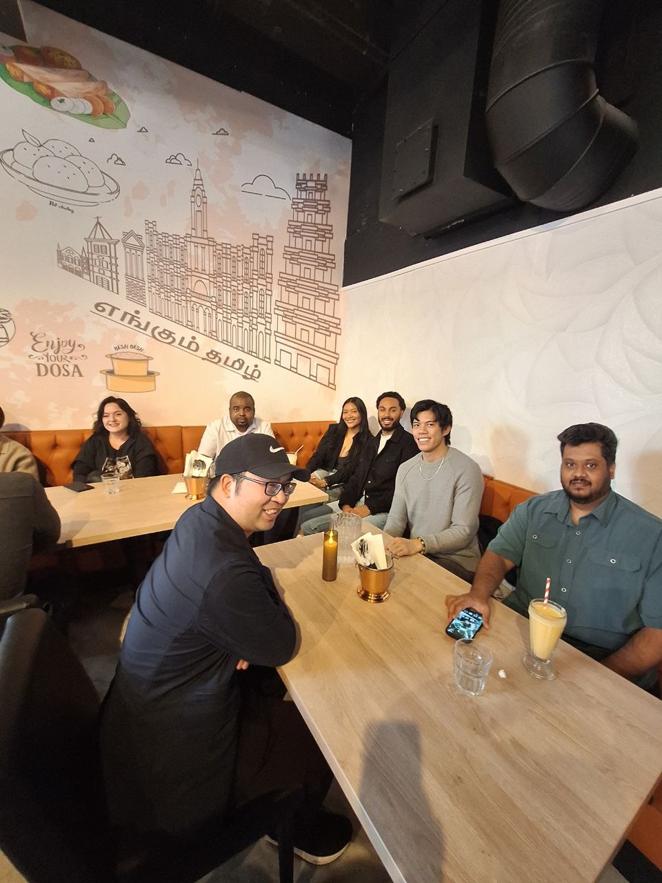 A restaurant room filled with Full Spread Party guests